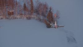 4K aerial stock footage snowy Cottonwood Lake, descend toward lighthouse, Wasilla, Alaska, sunset Aerial Stock Footage | AK0001_2089
