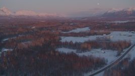 4K aerial stock footage fly over snow covered neighborhoods, reveal mountains, Palmer, Alaska, twilight Aerial Stock Footage | AK0001_2094