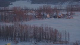 4K aerial stock footage passing a rural home with snow on the ground at twilight, Palmer, Alaska Aerial Stock Footage | AK0001_2096