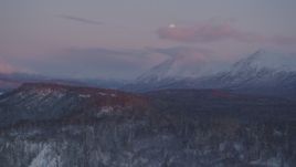 4K aerial stock footage snowy Chugach Mountains, moon, Matanuska River Valley, Alaska, twilight Aerial Stock Footage | AK0001_2103