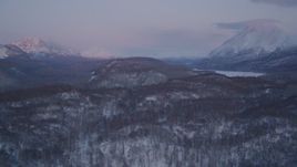 4K aerial stock footage snowy, wooded hills, Matanuska River Valley, Chugach Mountains, Alaska, sunset Aerial Stock Footage | AK0001_2109