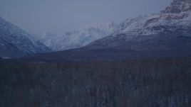 4K aerial stock footage flying by snow covered Talkeetna Mountains at twilight, Alaska Aerial Stock Footage | AK0001_2115
