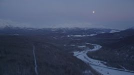 4K aerial stock footage moon over snowy Talkeetna Mountains, Matanuska River Valley, Alaska, twilight Aerial Stock Footage | AK0001_2116