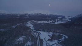 4K aerial stock footage snowy Matanuska River Valley, moon over Talkeetna Mountains, Alaska, twilight Aerial Stock Footage | AK0001_2117