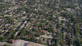 4.8K aerial  video flying over residential neighborhoods in Calumet City, Illinois, and reveal a shopping center Aerial Stock Footage | AX0001_003