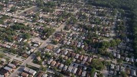 4.8K aerial stock footage reverse view of residential neighborhood with trees, Calumet City, Illinois Aerial Stock Footage | AX0001_004