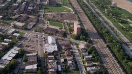 4.8K aerial stock footage tilt from homes by the train tracks to reveal the Downtown Chicago skyline, Illinois Aerial Stock Footage | AX0001_013
