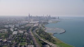 4.8K aerial stock footage of the Downtown Chicago skyline and Lake Michigan, on a hazy day, Illinois Aerial Stock Footage | AX0001_014