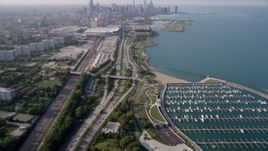 4.8K aerial stock footage tilt from 31st Street Harbor and Highway 41, revealing Downtown Chicago skyline, on a hazy day, Illinois Aerial Stock Footage | AX0001_016