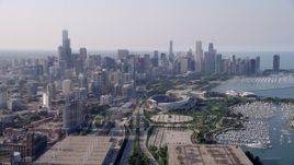 4.8K aerial stock footage following Highway 41 toward Soldier Field and Downtown Chicago skyline, on a hazy day, Illinois Aerial Stock Footage | AX0001_019
