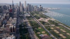 4.8K aerial stock footage tilt from One Museum Park, revealing Grant Park and Downtown Chicago skyscrapers, on a hazy day, Illinois Aerial Stock Footage | AX0001_023