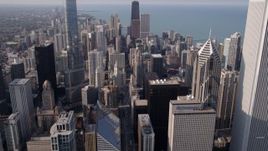 4.8K aerial stock footage of The Jay Pritzker Pavilion, revealing Downtown Chicago skyscrapers, on a hazy day, Illinois Aerial Stock Footage | AX0001_026