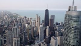 4.8K aerial stock footage of John Hancock Center while flying over Downtown Chicago, revealing Trump International, Illinois Aerial Stock Footage | AX0001_035