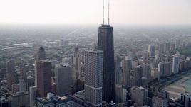 4.8K video of the top of John Hancock Center, hazy, Downtown Chicago, Illinois Aerial Stock Footage | AX0001_039