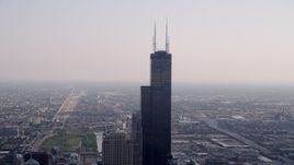4.8K aerial stock footage orbiting Willis Tower, hazy day, Downtown Chicago, Illinois Aerial Stock Footage | AX0001_042