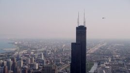 4.8K aerial stock footage orbiting the top of the Willis Tower on a hazy day, Chicago, Illinois Aerial Stock Footage | AX0001_043