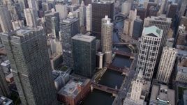 4.8K aerial stock footage following the Chicago River through downtown skyscrapers toward Marina City, Downtown Chicago, Illinois Aerial Stock Footage | AX0001_047