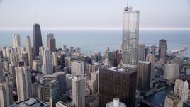 4.8K aerial stock footage following the Chicago River, tilt up revealing Trump Tower and John Hancock Center, Downtown Chicago, Illinois Aerial Stock Footage | AX0001_048