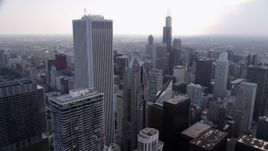 4.8K aerial stock footage orbiting Aon Center and Two Prudential Plaza, on a hazy day, Downtown Chicago, Illinois Aerial Stock Footage | AX0001_050