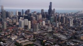 4.8K aerial stock footage tilting up from heavy traffic on Interstate 90 and 94, revealing Downtown Chicago skyscrapers, Illinois Aerial Stock Footage | AX0001_065