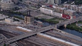 4.8K aerial stock footage of reverse view of a barge chugging down the Chicago River, Illinois, seen from a riverfront train yard Aerial Stock Footage | AX0001_073