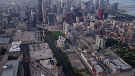 4.8K aerial stock footage tilting from Metra Railroad Yard and Chicago River, reveal hazy Downtown Chicago, Illinois Aerial Stock Footage | AX0001_078