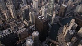 4.8K aerial stock footage of Bird's eye of Marina City and Chicago River, tilt up revealing skyscrapers, on a hazy day, Illinois Aerial Stock Footage | AX0001_084