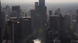 4.8K aerial stock footage passing the Chicago River and downtown skyscrapers on a hazy day, Downtown Chicago, Illinois Aerial Stock Footage | AX0001_093