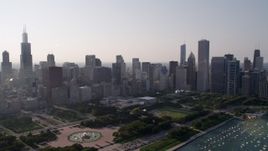 4.8K aerial stock footage video tilt from Lake Michigan, revealing the harbor, Grant Park, and Downtown Chicago skyline, Illinois Aerial Stock Footage | AX0001_101