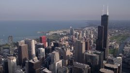 4.8K aerial stock footage of Willis Tower and Downtown Chicago skyscrapers on a hazy day, Illinois Aerial Stock Footage | AX0001_109
