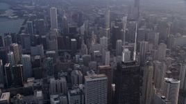 4.8K aerial stock footage of the top of John Hancock Center and Downtown Chicago skyscrapers, on a hazy day, Illinois Aerial Stock Footage | AX0001_127
