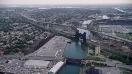 4.8K aerial stock footage following Calumet River toward the High Bridge and Chicago Skyway, on a hazy day, Illinois Aerial Stock Footage | AX0001_164