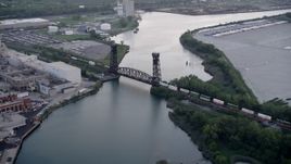 4.8K aerial stock footage tracking a train crossing a bridge spanning the Calumet River in Hegewisch, Chicago, Illinois Aerial Stock Footage | AX0001_171