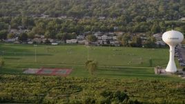 4.8K aerial stock footage players playing football at Thornton Fractional South High School in Lansing, on a hazy day, Illinois Aerial Stock Footage | AX0001_178