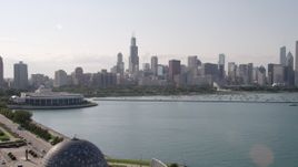 4.8K aerial stock footage tilt from Lake Michigan to reveal Adler Planetarium and Astronomy Museum and Downtown Chicago skyline, Illinois Aerial Stock Footage | AX0002_004