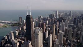 4.8K aerial stock footage an orbit of John Hancock Center, with the Downtown Chicago cityscape in the background, Illinois Aerial Stock Footage | AX0002_015