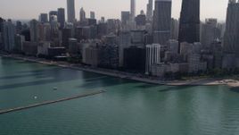 4.8K aerial stock footage tilt from Lake Michigan revealing John Hancock Center and Downtown Chicago skyscrapers, Illinois Aerial Stock Footage | AX0002_022