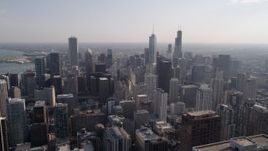 4.8K aerial stock footage of flying over Downtown Chicago toward Trump Tower Chicago on a hazy day, Illinois Aerial Stock Footage | AX0002_025