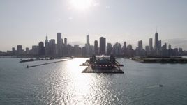 4.8K aerial stock footage of a reverse view of Navy Pier and the Downtown Chicago skyline seen from Lake Michigan, Illinois Aerial Stock Footage | AX0002_046
