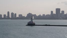 4.8K aerial stock footage of an orbit of Chicago Harbor Lighthouse with Downtown Chicago skyline in the background, Illinois Aerial Stock Footage | AX0002_048