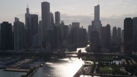 4.8K aerial stock footage approach skyline and bridge over Chicago River, with sun reflecting on water, Downtown Illinois Aerial Stock Footage | AX0002_051