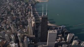 4.8K aerial stock footage approach spires atop John Hancock Center and tilt down, Downtown Chicago, Illinois Aerial Stock Footage | AX0002_073