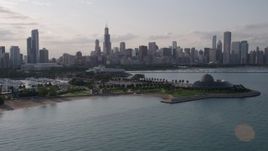 4.8K aerial stock footage of the Downtown Chicago skyline seen while flying by Adler Planetarium, Illinois Aerial Stock Footage | AX0002_088
