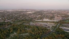 4.8K aerial stock footage of a Hammond residential neighborhood and warehouse buildings, on a hazy day, at sunset, Hammond, Indiana Aerial Stock Footage | AX0003_008