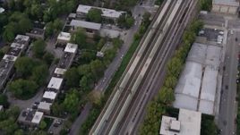 4.8K aerial stock footage of a bird's eye view of train tracks in Kenwood, at twilight, Chicago, Illinois Aerial Stock Footage | AX0003_019