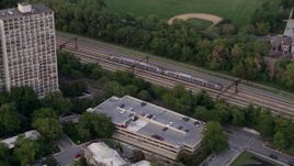 4.8K aerial stock footage of a commuter train passing through Kenwood, Illinois, twilight Aerial Stock Footage | AX0003_021