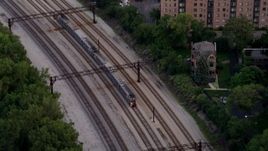 4.8K aerial stock footage track commuter train traveling through Kenwood at twilight, Chicago, Illinois Aerial Stock Footage | AX0003_027