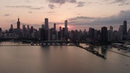 4.8K aerial stock footage of the Downtown Chicago skyline, reveal Navy Pier, cloudy sunset, Illinois Aerial Stock Footage | AX0003_033