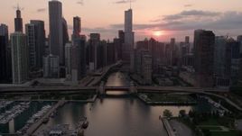 4.8K aerial stock footage tilt from the lake to reveal Downtown Chicago at sunset with clouds, Illinois Aerial Stock Footage | AX0003_034