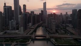 4.8K aerial stock footage approach and fly over the bridge at mouth of Chicago River at sunset, Downtown Chicago, Illinois Aerial Stock Footage | AX0003_035